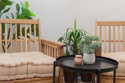 a black table with two chairs and a table with plants at Stylish downtown charm in Valencia