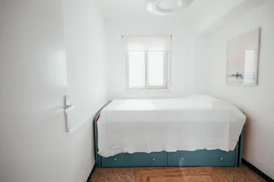 a bed in a room with a window at Garden at 50m from beach, ChillOut, Large Porche in Mareny Blau