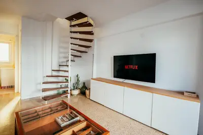 a living room with a tv and a staircase at Garden at 50m from beach, ChillOut, Large Porche in Mareny Blau