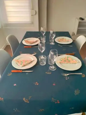 a blue table with plates and glasses on it at Apartament El Colomer 3 habitacions in Simat de Valldigna