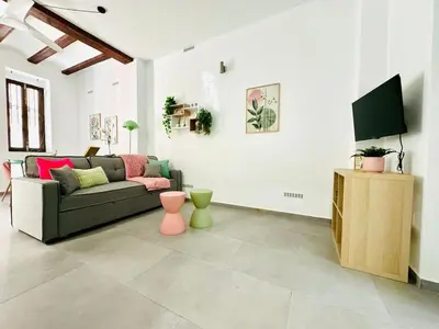 a living room with a couch and a tv at Cute & Cozy Aparment Near The Historic Center in Valencia