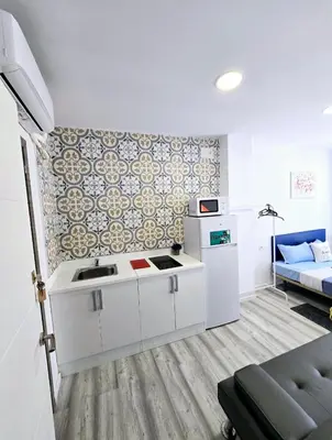 a small room with a sink and a refrigerator at Apartamentos Lindux Airport in Manises