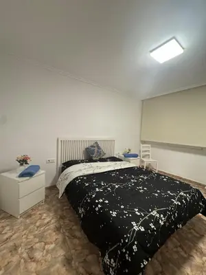 a bedroom with a large bed with a black blanket at Escapate con estilo en Valencia in Valencia