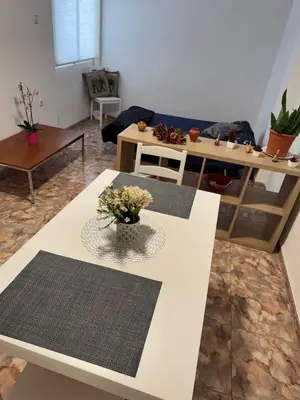 a living room with a white table with flowers on it at Escapate con estilo en Valencia in Valencia