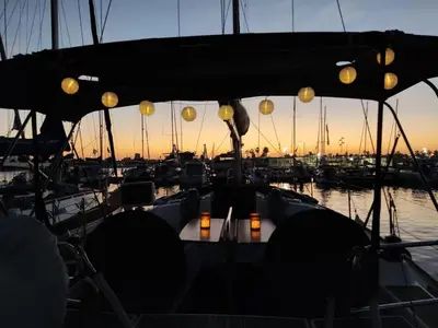 a table on the back of a boat in the water at Magnificent sailboat with free parking for cars in Valencia