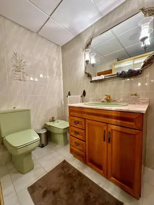 a bathroom with a toilet and a sink and a mirror at Wagner Playa Apartment in Cullera