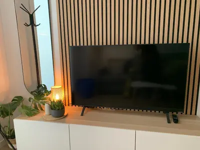 a large flat screen tv sitting on top of a cabinet at Nieuw Appartement in El Carmen in Valencia