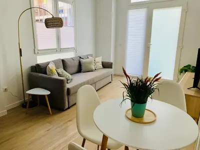 a living room with a table and a couch at Nieuw Appartement in El Carmen in Valencia