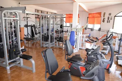 a gym with a bunch of treadms and machines at Complejo Turistico la Pinada in Gilet