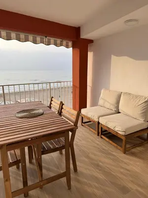 a living room with a table and a couch at Apartamento en Primera Línea in Cullera