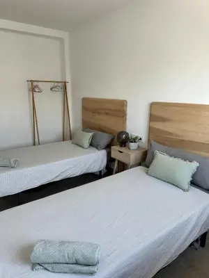 a room with two beds in a room at Abadesa Apartments in Benetúser