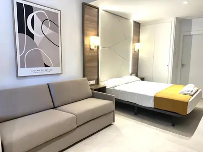 a living room with a bed and a couch at Marina Azura in Valencia