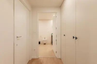 a hallway with a toilet in a white room at Doce de Colón C in Requena