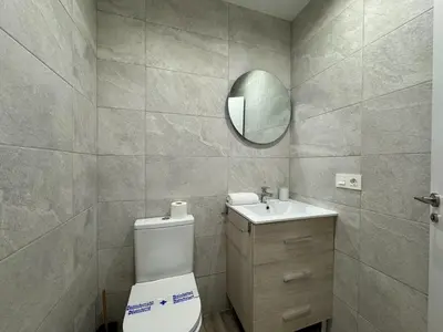 a bathroom with a toilet and a mirror at Reino Vlc - centrico y amplio piso in Valencia