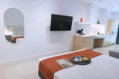 a white room with a bed and a sink at Olmaya Flats Valencia in Valencia
