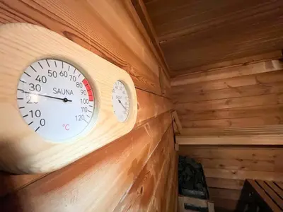 a clock on a wall in a log cabin at Casa Burriana con sauna in Burriana
