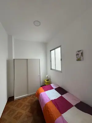 a bedroom with a bed and a window at Ático en el centro con terraza in Valencia