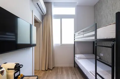 a small bedroom with a bunk bed and a window at Rubio Rooms by Concept in Valencia