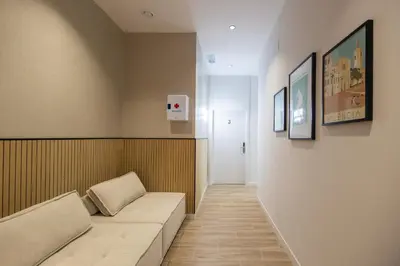 a hospital room with a couch and a hallway at Rubio Rooms by Concept in Valencia