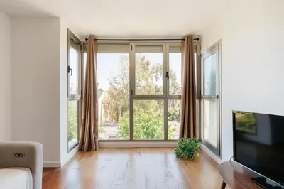 a living room with a large window and a television at Premium, Lux & Comfort by the Sea in Valencia
