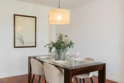 a dining room table with chairs and a vase of flowers at Premium, Lux & Comfort by the Sea in Valencia