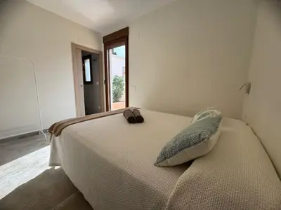 a bedroom with a bed with a pair of shoes on it at Piscina & Espacio & Confort entre Playa y Montaña in San Antonio de Banageber