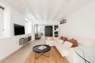 a white living room with a white couch and a table at Comfort & Charm in the Center in Valencia