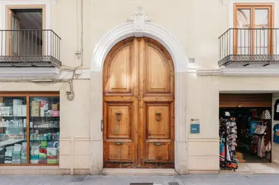 a large wooden door on the side of a building at Comfort & Charm in the Center in Valencia