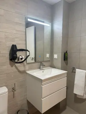 a bathroom with a sink and a mirror and a toilet at Valencia Breeze in Alaquas