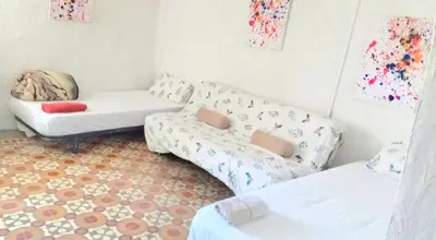 a living room with a couch and a chair at Casa Cueva Puerta Verde in Paterna