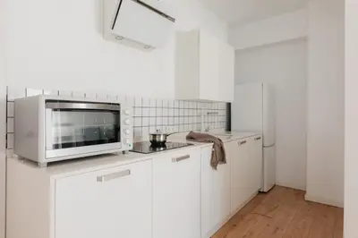 a kitchen with white cabinets and a microwave at Penthouse with Terrace 2 Bedrooms 2 Bathrooms in Valencia