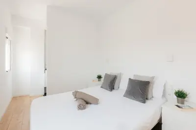a white bedroom with a large white bed at Penthouse with Terrace 2 Bedrooms 2 Bathrooms in Valencia