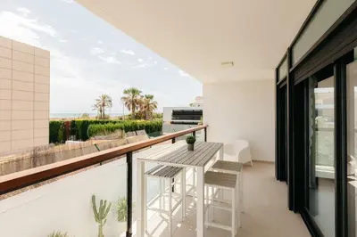 a room with a balcony with a table and chairs at Grand Villa with Pool in Sagunto