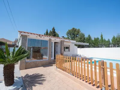 a house with a fence and a swimming pool at Villa a un paso de Valencia in Riba-Roja De Turia