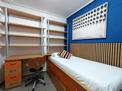 a bedroom with a desk and a bed and a desk and chair at Valencia Playa Patacona Resort in Valencia