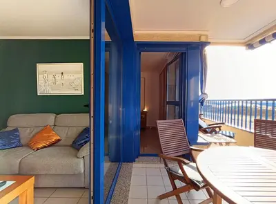 a living room with a couch and a table at Valencia Playa Patacona Resort in Valencia