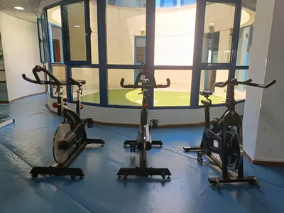 a gym with three exercise bikes in a room at Valencia Playa Patacona Resort in Valencia