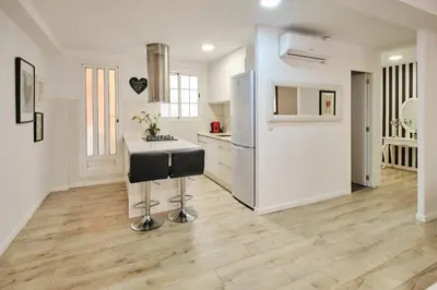 a kitchen with a counter and a refrigerator at Serrano flat in Valencia