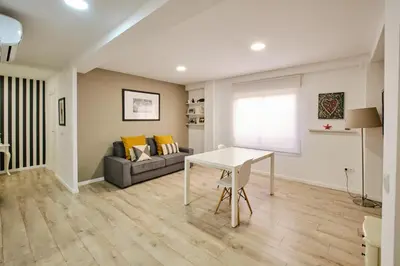 a living room with a table and a couch at Serrano flat in Valencia