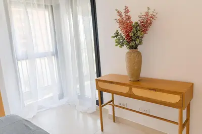 a vase of flowers on a table next to a window at Valencia Beach Home 8 in Valencia