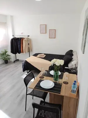 a living room with a table and a couch at loft cerca del centro de Valencia in Valencia