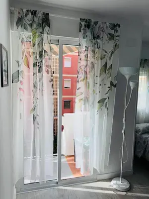 a room with a sliding glass door with a window at Loft con balcón cercano al centro de Valencia in Valencia