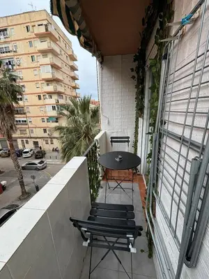 a balcony with a table and chairs on a building at Loft con balcón cercano al centro de Valencia in Valencia