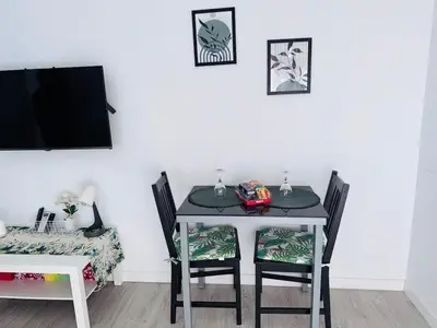a dining room table with two chairs and a tv at Loft con balcón cercano al centro de Valencia in Valencia