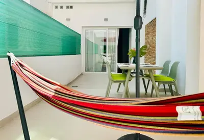 a hammock in a room with a table and chairs at PLANAS 2 Design & Spaciousness with Terraza in Ruzafa SOHO in Valencia