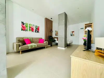 a living room with a couch and a tv at PLANAS 3 Designer Aparment with Terraza in Ruzafa SOHO in Valencia