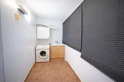 a laundry room with a washer and dryer in it at Dúplex tranquilo frente al mar en Xilxes Terraza, parking y WiFi in Chilches