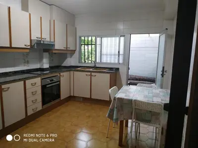 a small kitchen with a table and a table and chairs at EL Cid II in Valencia
