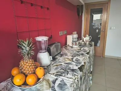 a table with a blender and a bowl of fruit on it at luxury and relax in Valencia