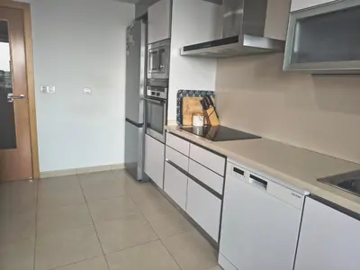 a kitchen with white cabinets and stainless steel appliances at luxury and relax in Valencia
